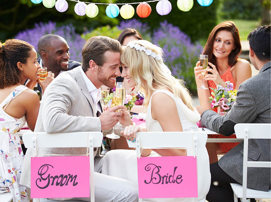 Bride And Groom Enjoying Meal At Wedding Reception