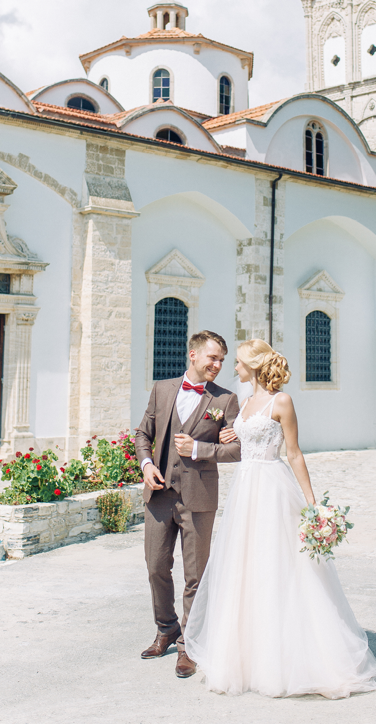 Wedding on the city streets of Cyprus. Beautiful couple walking and laughing, the architecture of the city.