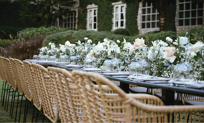 Beautiful flowers decorated on the table.Tables set for an event party or wedding reception. luxury elegant table setting dinner in a restaurant. glasses and dishes. 