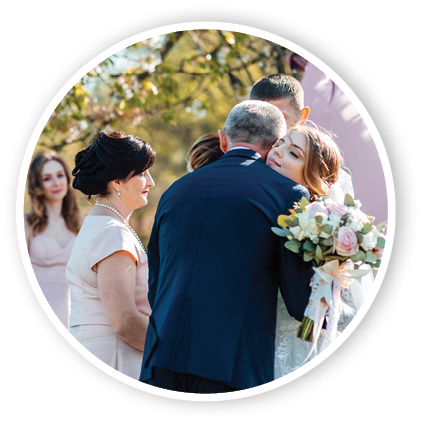 Bride and groom after wedding ceremony  Parents welcome newlyweds to marry  Stylish happy smiling newlyweds on the outdoor