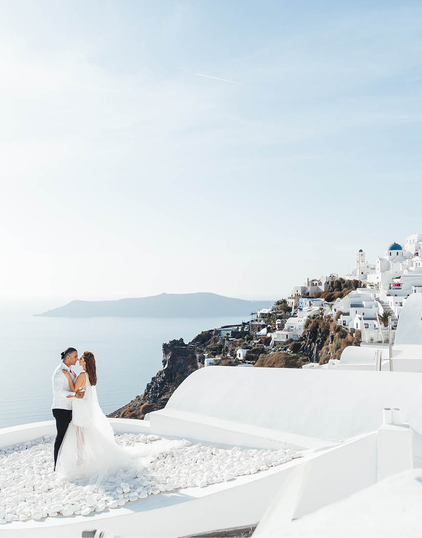 Wedding on Santorini island in Greece, beautiful couple, bride in a white wedding dress  White houses and blue sky