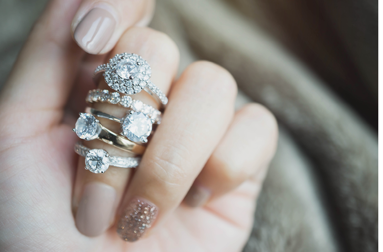 Close up of an elegant diamond rings on woman finger love and wedding concept soft and selective focus 