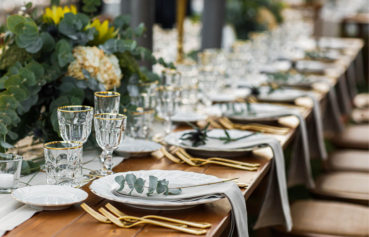 Decorated plate with fork and spoon  Table set up in boho style with pampas grass and greenery