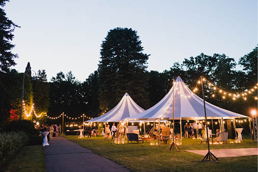 Coziness and style  Modern event design  Lounge zone and wedding reception decorations outdoors in the evening 