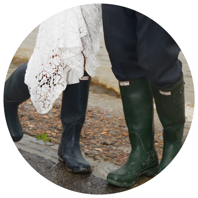 London, UK - 24 August 2013: Bride and groom at a wet wedding with wellington boots
