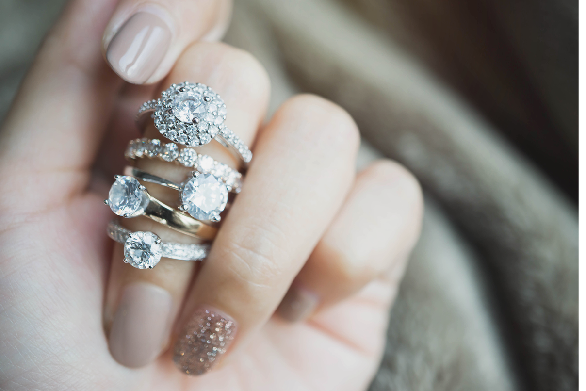 Close up of an elegant diamond rings on woman finger love and wedding concept soft and selective focus 