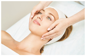 Face massage at spa salon. Doctor hands. Pretty female patient. Beauty treatment. Healthy skin procedure. Young woman head. Light background. Scrub rejuvenation. Facial dermatology mask. Detox therapy