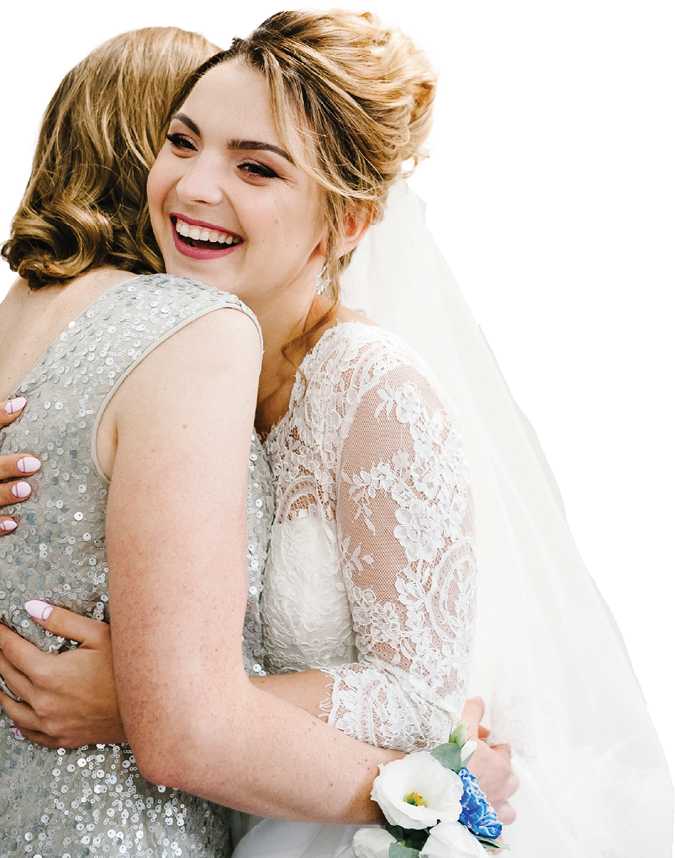 Mom congratulates the bride with a marriage and hugs. woman welcomes. Happy bride with mother on background white wall in home. Wedding ceremony. Close up