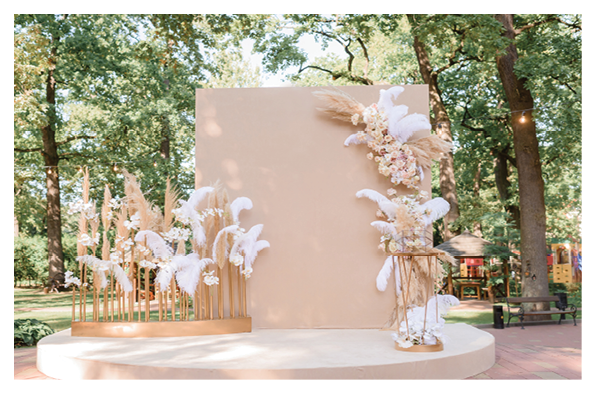 Front view of fashion trendy arch decorated with fresh flowers and other decor. Concept of wedding ceremony details.