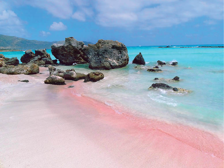 beach coast with pink sand sea landscape and mountains on Crete island