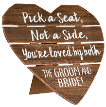 Shot of ceremony signage, pick a seat either side on a wedding day with a blurred background