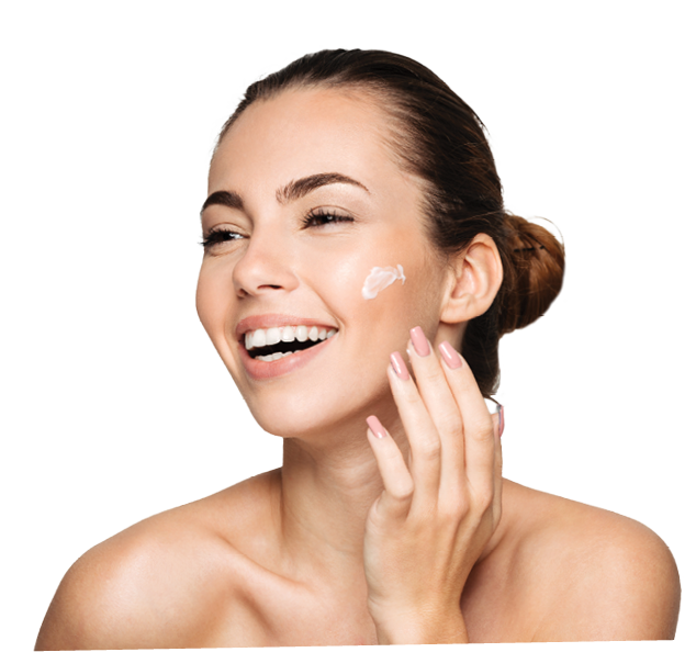 Close up beauty portrait of a laughing beautiful half naked woman applying face cream and looking away isolated over white background