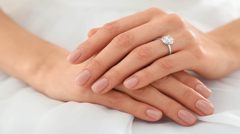 Young bride wearing beautiful engagement ring, closeup