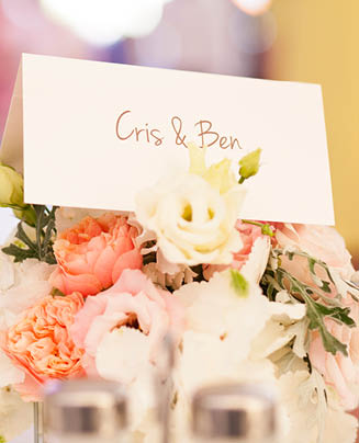 Wedding table decoration with flower, candle lights and place cards