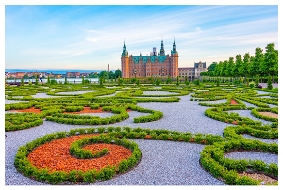 Sunset view of gardens of Frederiksborg Slot palace in Denmark.