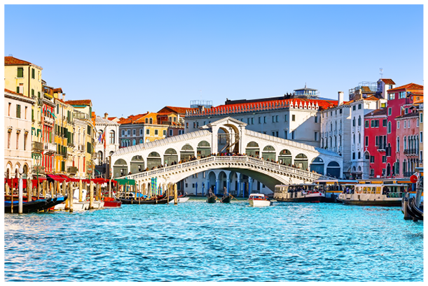 View of Grand Canal with Rialto Bridge and gondoliers in Venice, Italy. Landscape with Rialto Bridge and gondola on the Grand Canal in Venice, Italy, Europe. 
