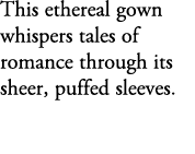 This ethereal gown whispers tales of romance through its sheer, puffed sleeves.