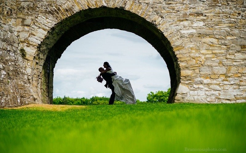 Groom lifts bride
