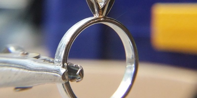 Man studies jewellery design to propose with a handmade engagement ring