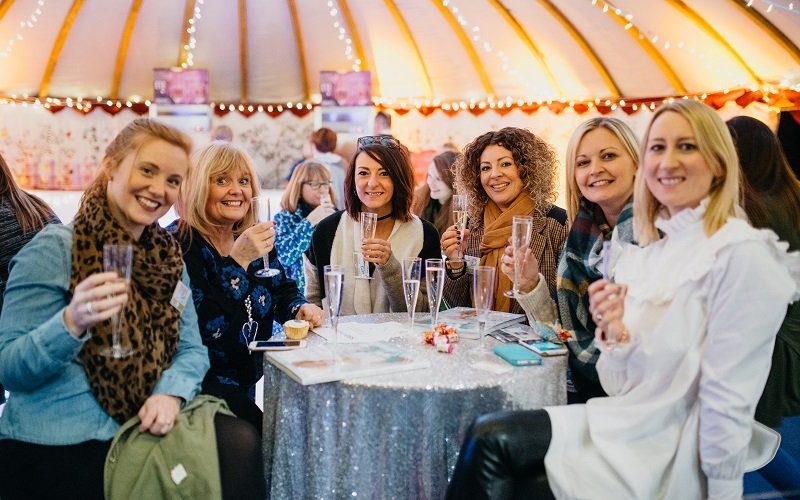 girls in tent with prosecco