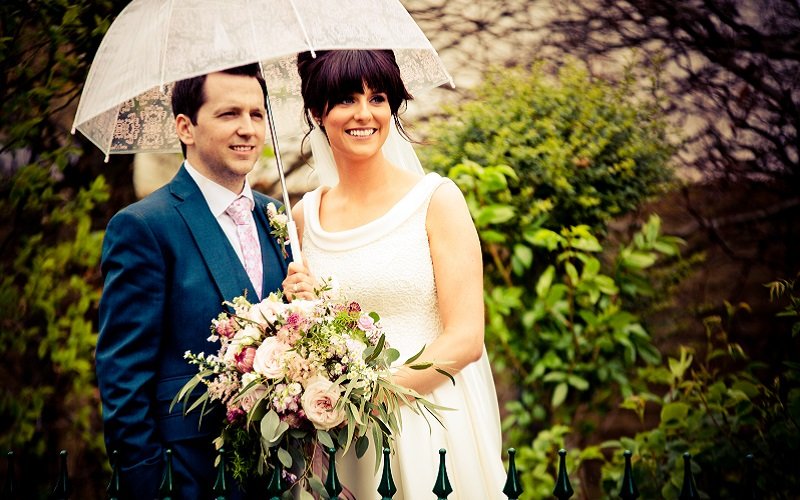bride and groom with umbrella